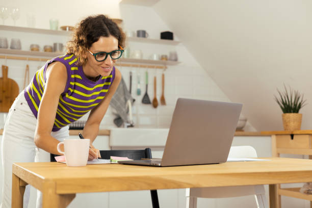 istock Young woman starting her working day at home office 1425338880