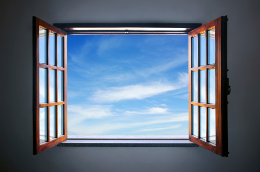 Wide open rustic window showing a blue sky outside