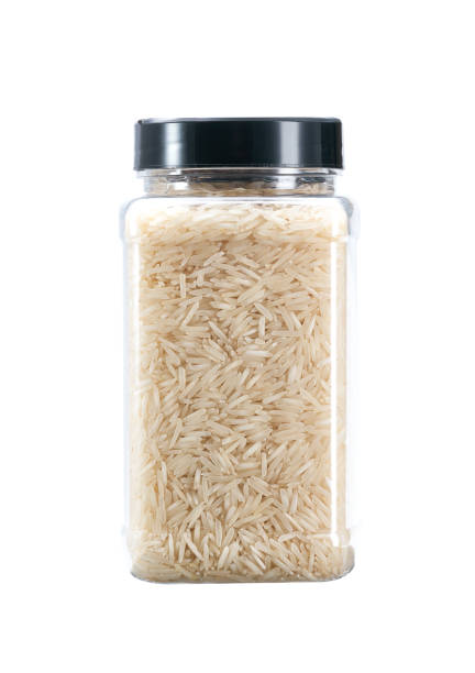 istock plastic jar with uncooked long rice basmati isolated on white background. 1425349455