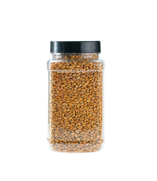 istock plastic jar with uncooked wheat grains isolated on white background. 1425349456