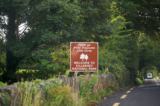 Road sign that reads Welcome to Killarney National Park in English and Irish