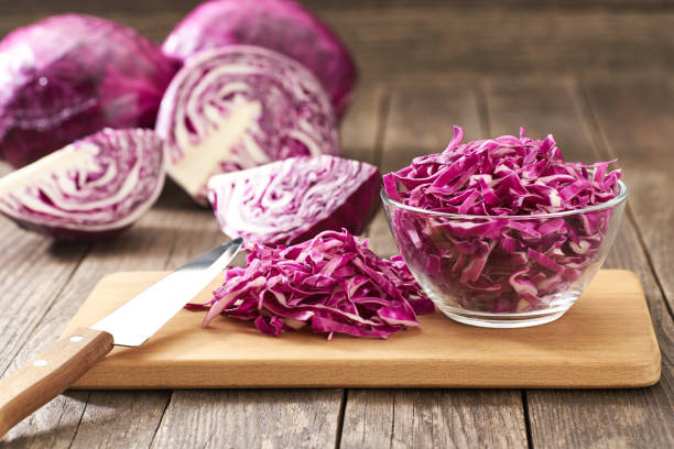 istock Cut red cabbage on wooden table with copy space for text. 1425355994