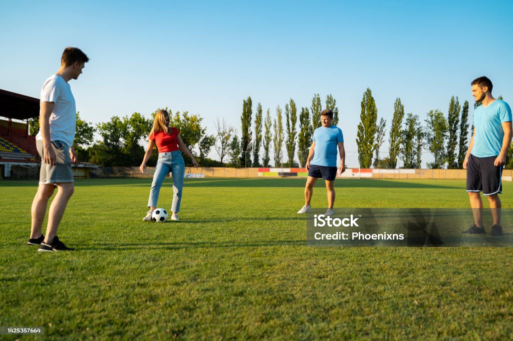 Group of people deferent age playing soccer for fun, team 20-24 Years Stock Photo