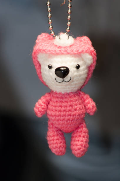 istock Hand made key ring knitted doll in pink color 1425357800