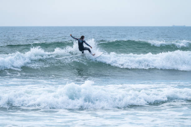 istock Surfer girl riding a wave 1425361464