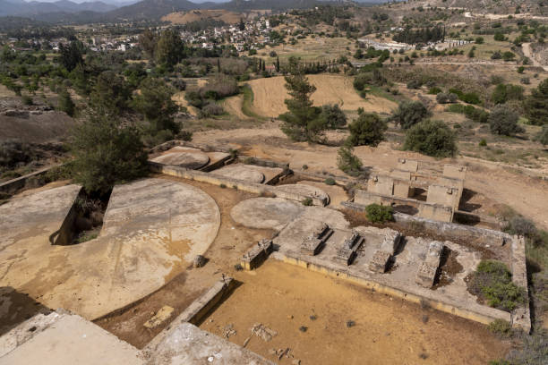 istock Wide view of historic gold processing site foundations on hillside with village and mountain range in the background 1425361466