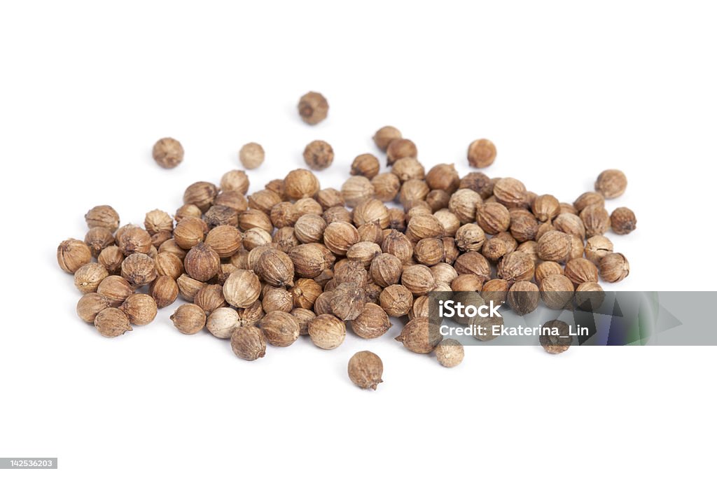Heap Coriander Seeds (Coriandrum sativum) isolated on white back Heap Coriander Seeds (Coriandrum sativum) isolated on white background. Also called Cilantro or Dhania or Malli. Used in cooking and to give a pleasant scent in perfumery, cosmetics, soap-making. Brown Stock Photo