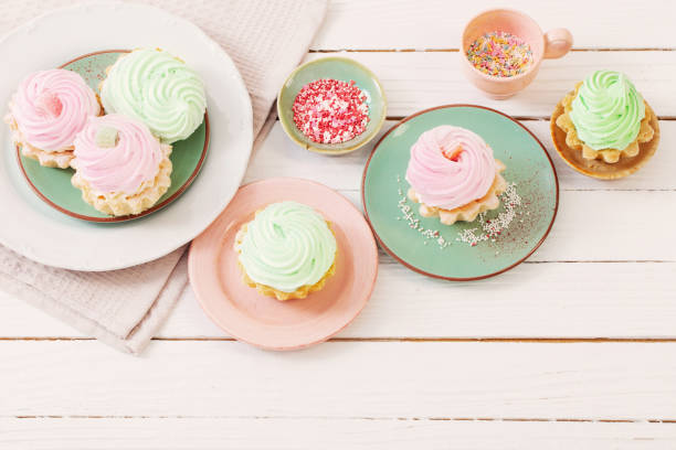 istock cupcakes on plates on white wooden background 1425367963