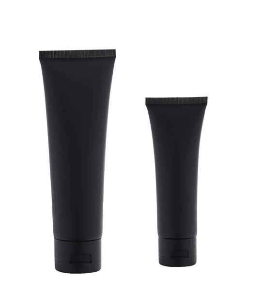 istock two black plastic bottles with night cosmetic cream or moisturizing lotion isolated on white background. 1425371394