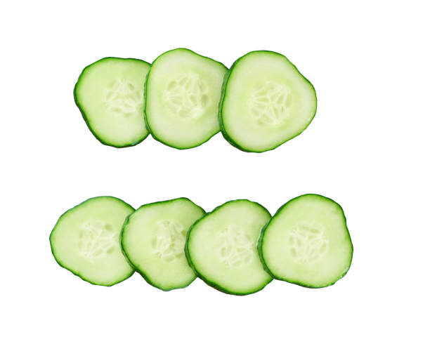istock Fresh cucumber slices isolated on a white background, top view. 1425377729