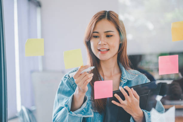 istock Web designers creating planning and analyzing with Colorful sticky notes on the office board.web design concept 1425378606