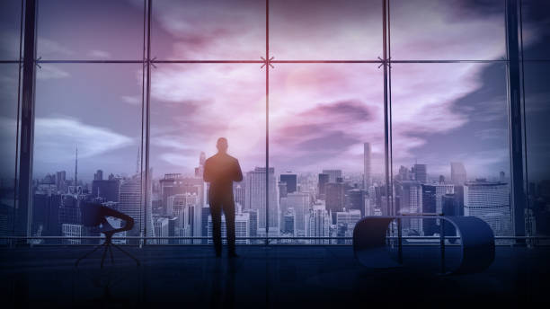 In a spacious office, a man looks at city buildings from above, 3D render. stock photo