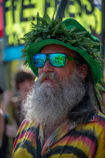 Nimbin, NSW; September 18, 2022Protestor marching in the 30th Mardi Grass parade. Nimbin.30th Mardi Grass. Every year the small NSW town of Nimbin {famous for the 1973 Aquarius Festival} holds a rally to march for the legalisation of cannabis. Law reform still has a long way to go even for the use of medicinal cannabis. The parade has a large number of colourful characters. It is a non ticketed public event. There are also sports games and a two day conference in  the town hall on the nature and future of cannabis. A feature of the parade is a group of dancing Ganja Faeries. They range form 8 to 80 and rehearse a travelling dance all year.
