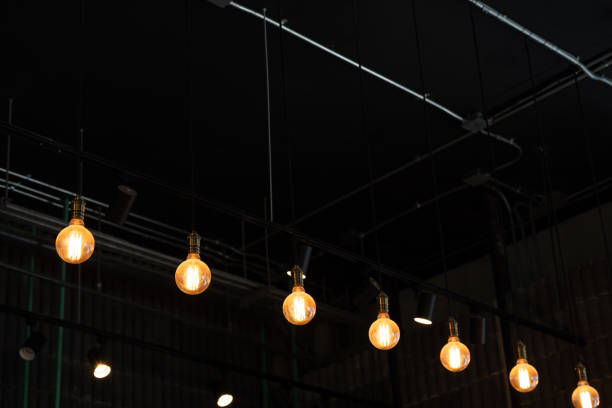 istock warm lights hanging from ceiling in local restaurant. 1425383756