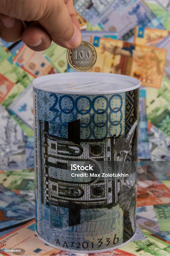 Piggy bank with the image of a banknote of 20,000 Kazakhstani tenge against the background of other Kazakhstani banknotes Almaty Stock Photo