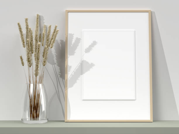 istock Blank picture frame for photographs, art, graphics with Leaves. Frame poster mockup template on the wall in home interior. 3D rendering 1425392098
