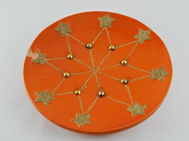 istock Twinkling stars on orange plate 1425395581