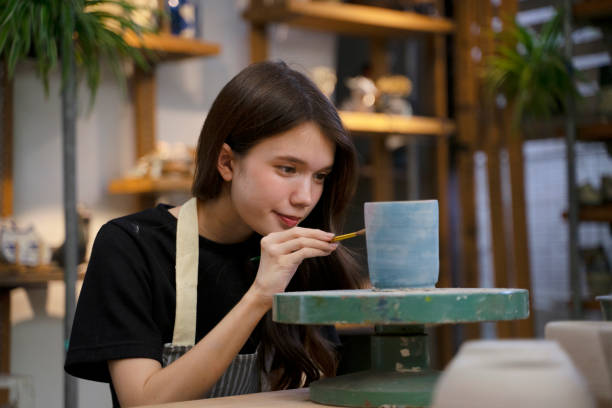 istock Young woman is making pottery as leisure activity. 1425397615