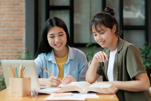 istock Young asian students campus helps friend catching up and learning. 1425400335