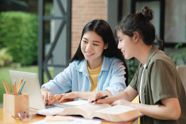istock Young asian students campus helps friend catching up and learning. 1425400345