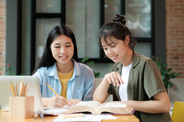 istock Young asian students campus helps friend catching up and learning. 1425400346