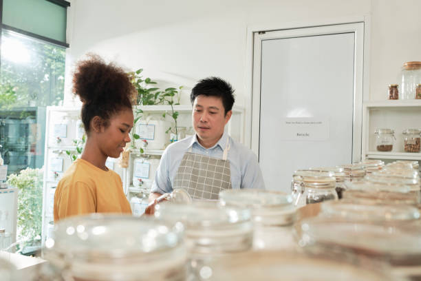 istock A shopkeeper and customer in refill store, zero-waste, and plastic-free grocery. 1425401626
