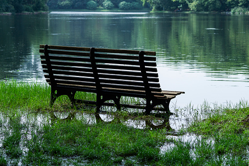 A bench in the water on the shore of the lake