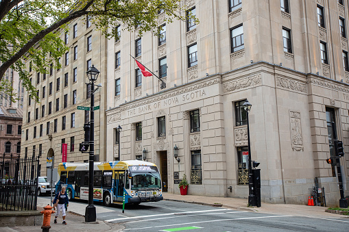 Halifax, Canada - August 30, 2022. Vehicles pass an old Bank of Nova Scotia, commonly referred to as Scotiabank.