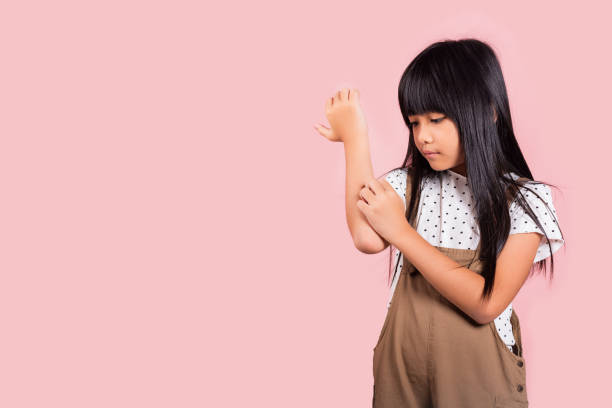 istock Asian little kid 10 years old scratching itch arm from a mosquito bite 1425404122