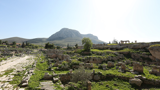 Acro Corinth in distance, with ancient ruins in foreground