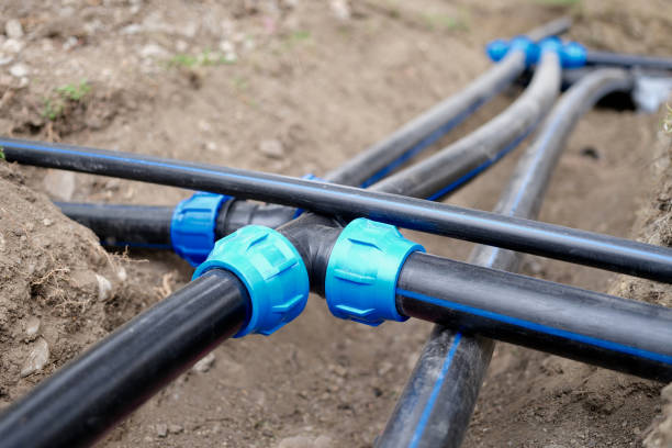 istock Connection of plastic sewer pipes closeup. Irrigation system for vegetable garden concept 1425409713