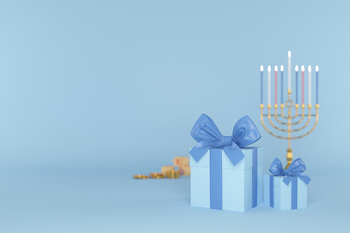 Young religious jewish man lighting candles on traditional menorah celebrating Hannukah