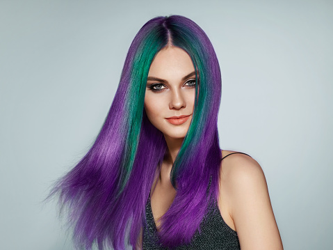 Beauty fashion model girl with colorful dyed hair. Girl with perfect makeup and hairstyle. Model with perfect healthy smooth hair