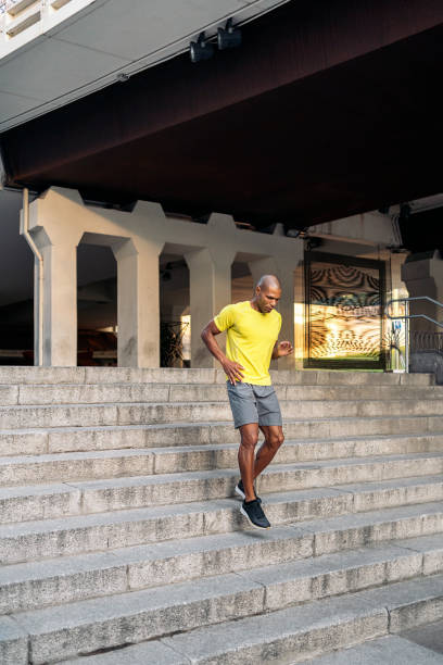 istock Sportsman jogging down on stairs outside 1425416337