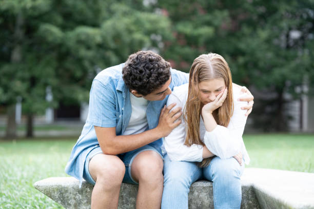 istock Hispanic boy comforting and hugging girlfriend 1425417944