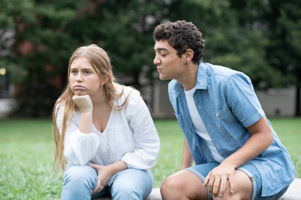 istock Hispanic boy trying to kiss distracted girlfriend 1425417990