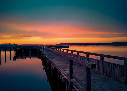 Boat jetty at dusk after colourful sunset in Ribnitz-Damgarten on the Saaler Bodden