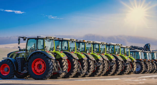 Exhibition / new tractors lined up next to each other in a row stock photo