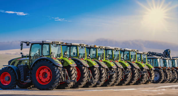 exhibition / new tractors lined up next to each other in a row - equipamento agrícola imagens e fotografias de stock