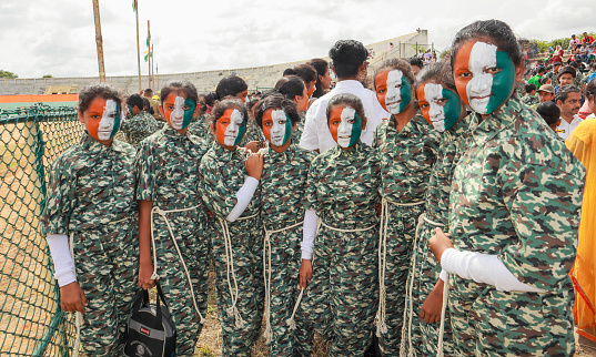 A Batch of School girls dressed in Army uniform and faces painted in National flag colors for the Independence day in Mysore, India.