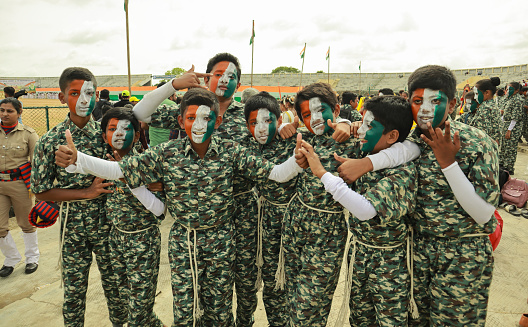 A Group of Young boys dressed up in Army uniform and faces painted in colors for a cultural event  on the Indian Independence day in Mysore, India.