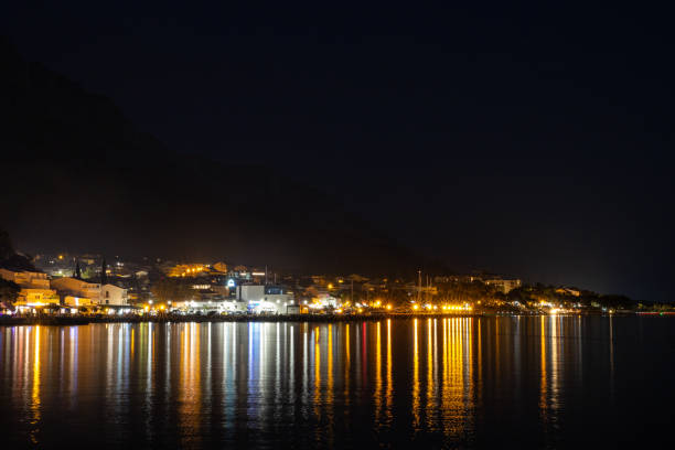 istock Seascape with a city on the coast at night. 1425423022