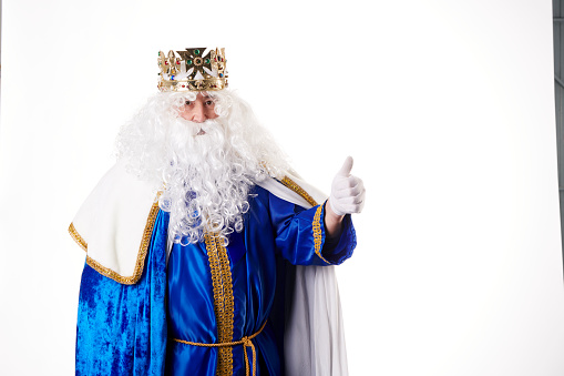 A king with white hair and beard on white background