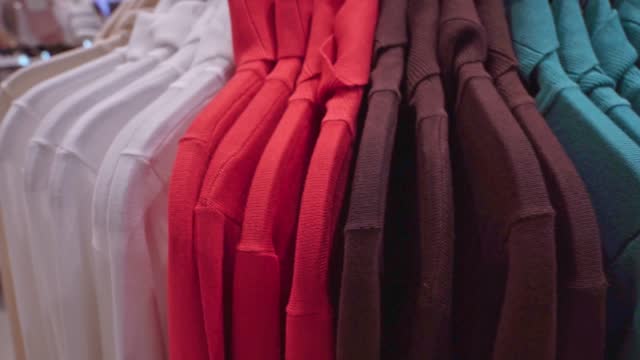 Close-up: casual clothes multi colored sweatshirts in clothing store