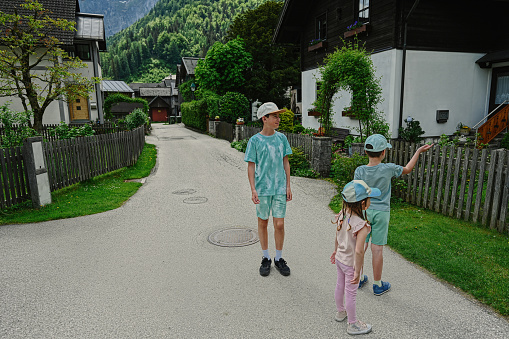 Three kids walking at old town Hallstatt,Austria.