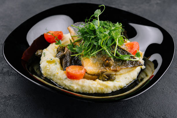 Fried norwegian skrei cod fish filet with mashed potatoes stock photo
