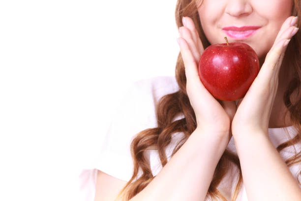 Young woman eating an apple