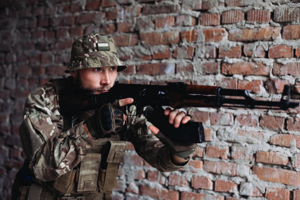 istock Soldier in war, with weapons in his hands, aim at the enemy 1425439272