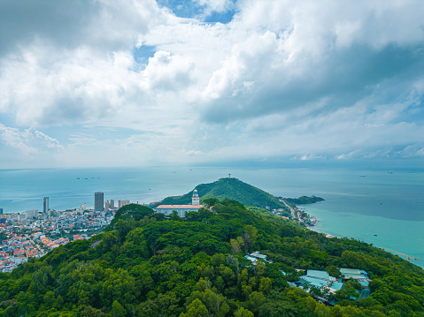 Top view of white Lighthouse in Vung Tau. The most visited tourist location in the Vung Tau city and famous Lighthouse captured with blue sky and cloud.