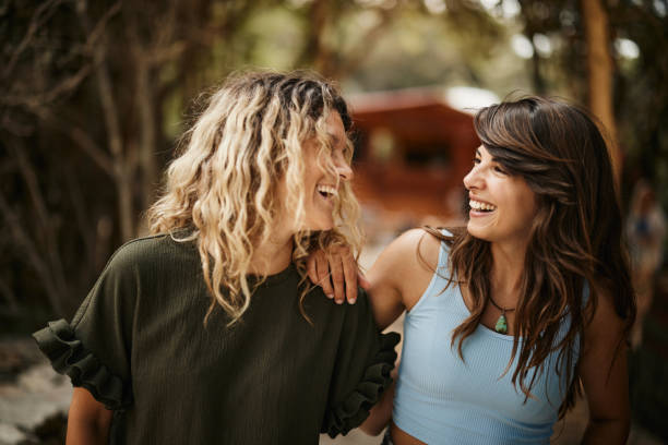 istock Happy female friends talking while walking embraced in nature. 1425445700